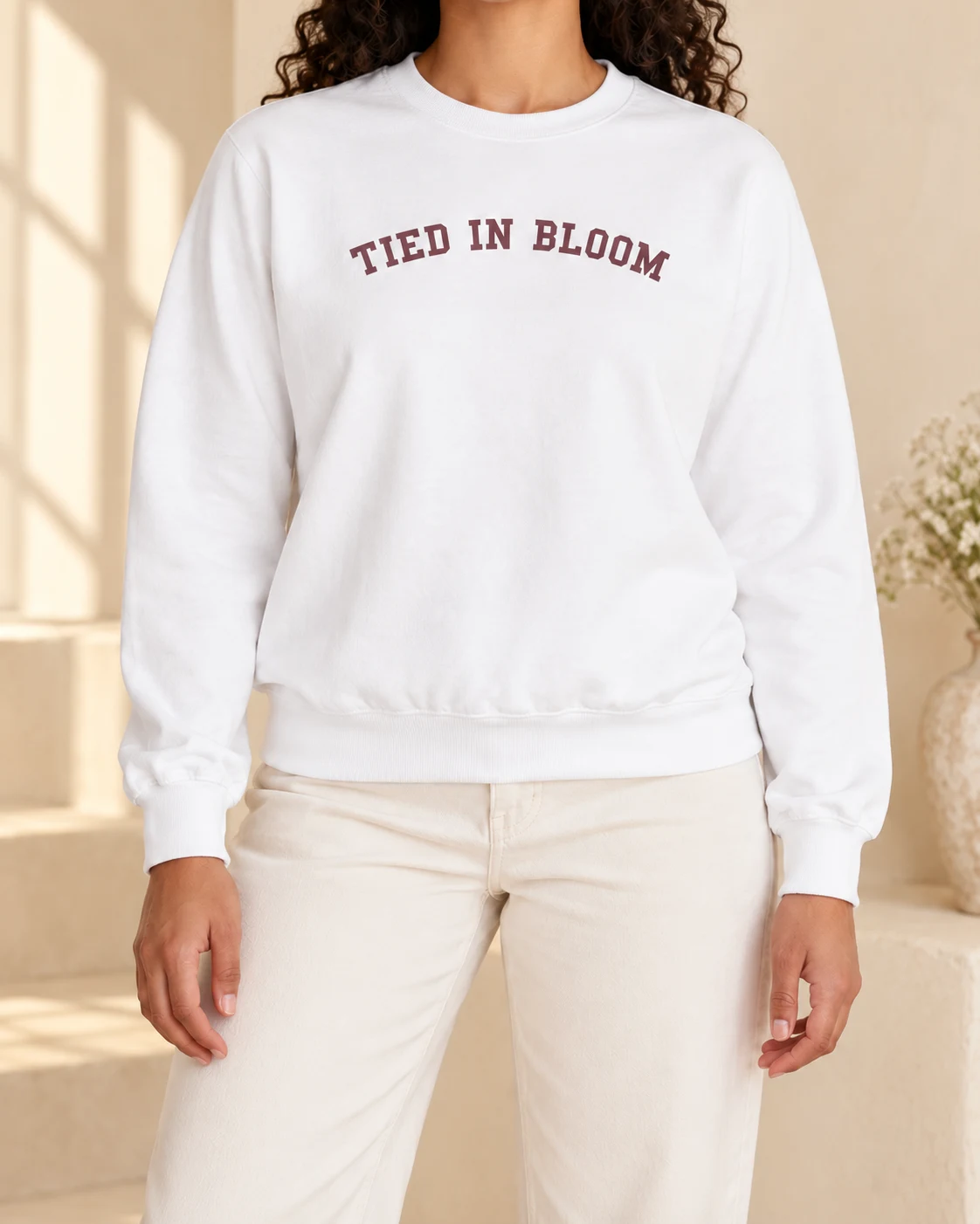 AI mockup of a woman wearing The Signature Arch Crew in White, cropped below the face.
